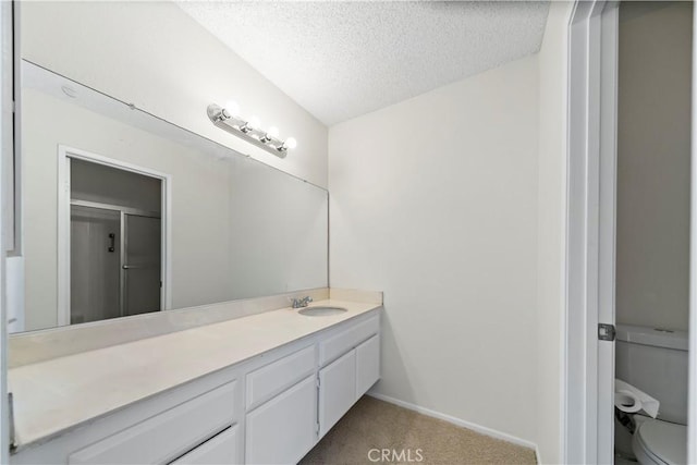 bathroom with toilet, a textured ceiling, an enclosed shower, and vanity