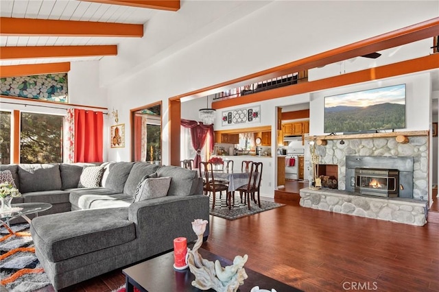 living room featuring wooden ceiling, wood-type flooring, a fireplace, and vaulted ceiling with beams