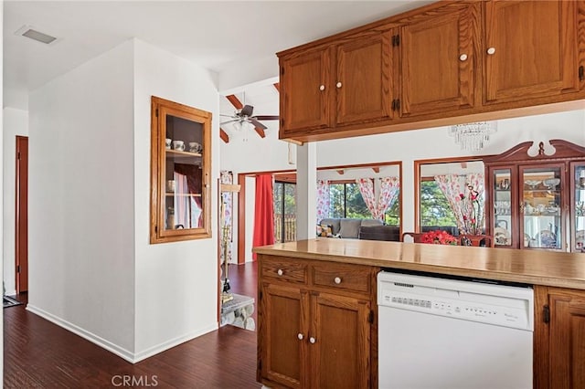 kitchen featuring lofted ceiling, dark wood-type flooring, white dishwasher, and ceiling fan with notable chandelier