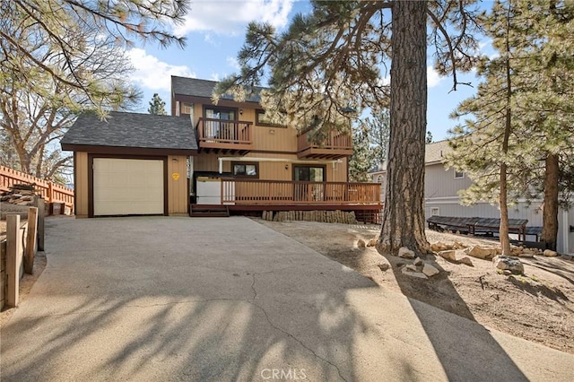 view of front of property featuring a garage and a balcony