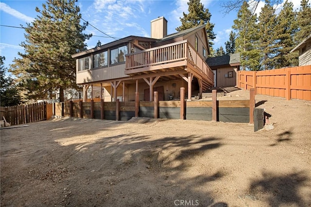 rear view of house featuring a wooden deck