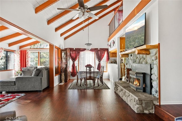 dining area featuring beam ceiling, ceiling fan, dark hardwood / wood-style flooring, and a wealth of natural light