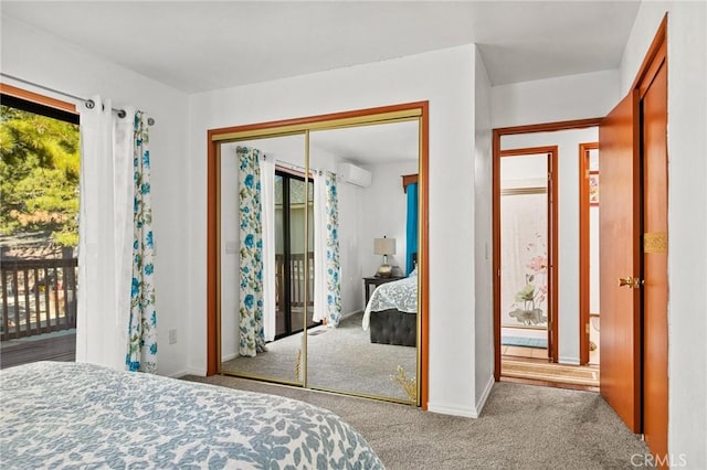 bedroom featuring a closet, light colored carpet, access to outside, and an AC wall unit