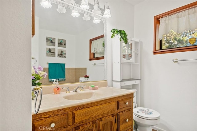 bathroom with toilet and vanity