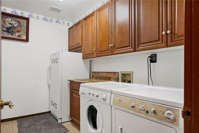 laundry area featuring cabinets and independent washer and dryer