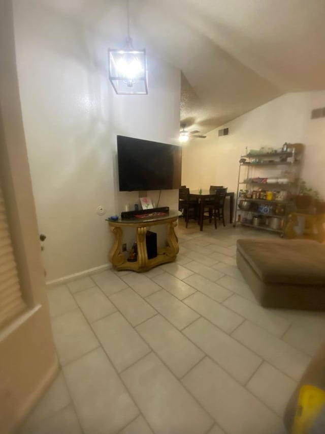 tiled living room featuring lofted ceiling and ceiling fan