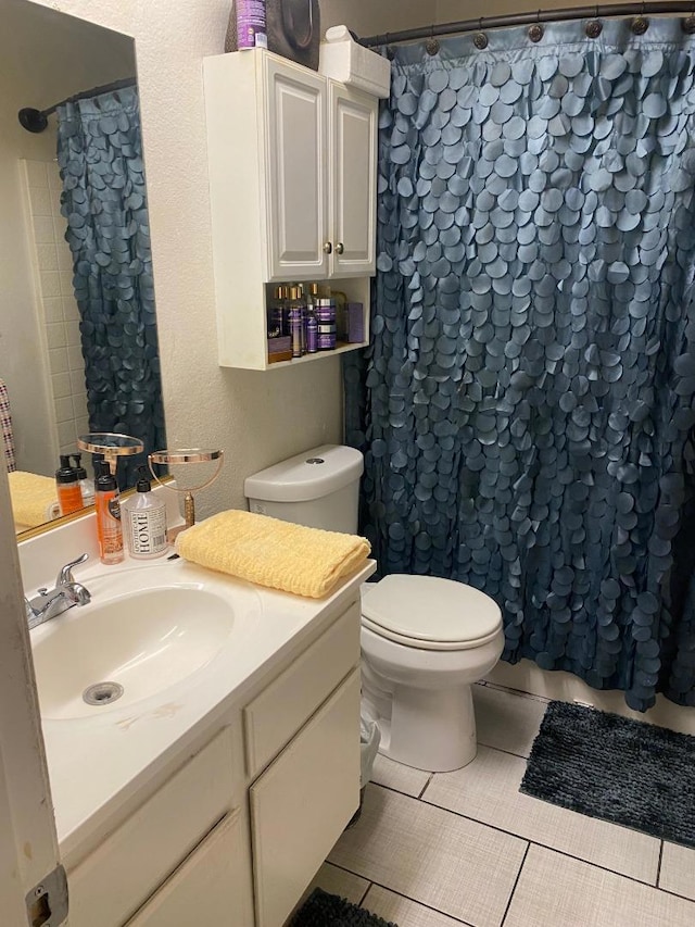 bathroom with vanity, toilet, tile patterned flooring, and a shower with shower curtain