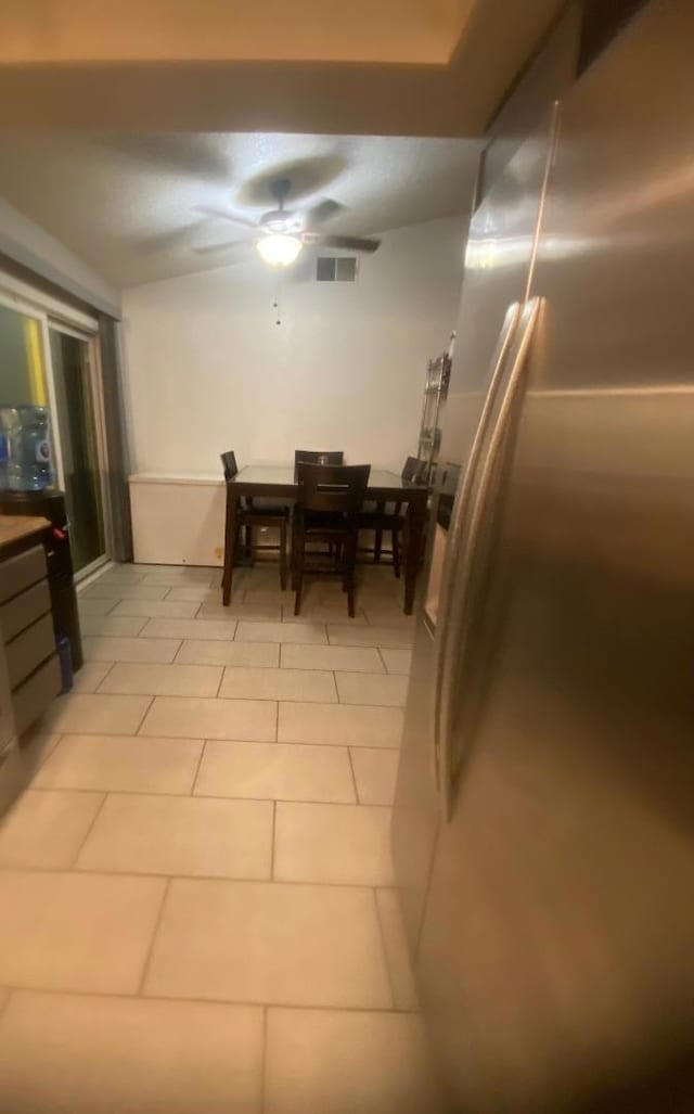 dining area featuring ceiling fan and light tile patterned flooring