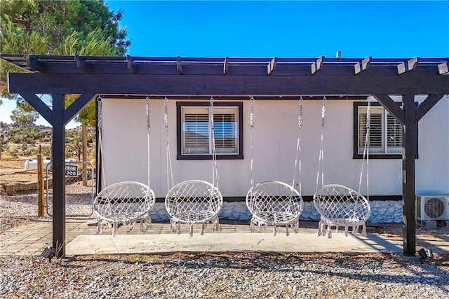 view of side of property featuring a patio and ac unit