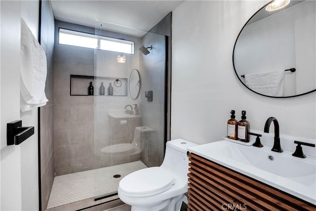 bathroom with an enclosed shower, vanity, and toilet