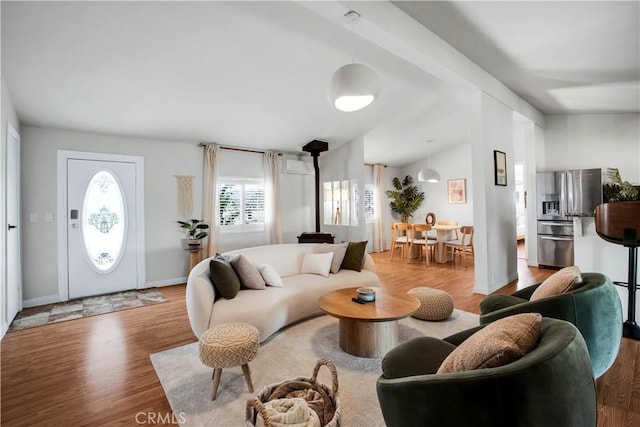 living room with lofted ceiling with beams and light wood-type flooring