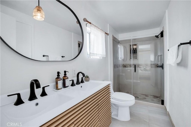 bathroom with vanity, tile patterned flooring, a shower with shower door, and toilet