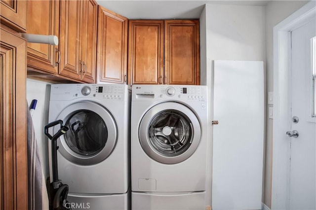 laundry area with cabinets and separate washer and dryer