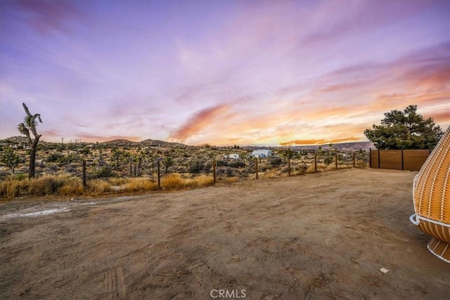 yard at dusk featuring a mountain view