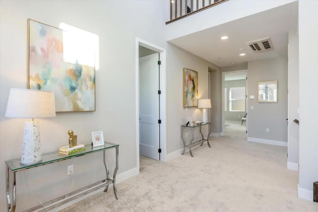 corridor with light colored carpet