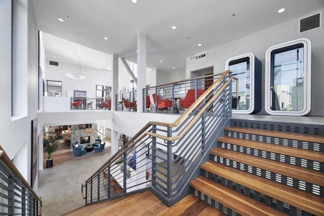 staircase with hardwood / wood-style flooring