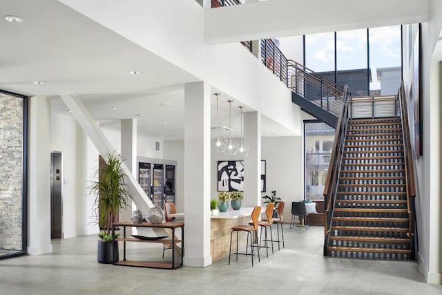 stairs featuring plenty of natural light and a high ceiling