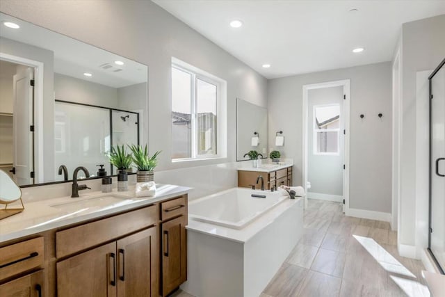 full bathroom featuring shower with separate bathtub, vanity, and toilet