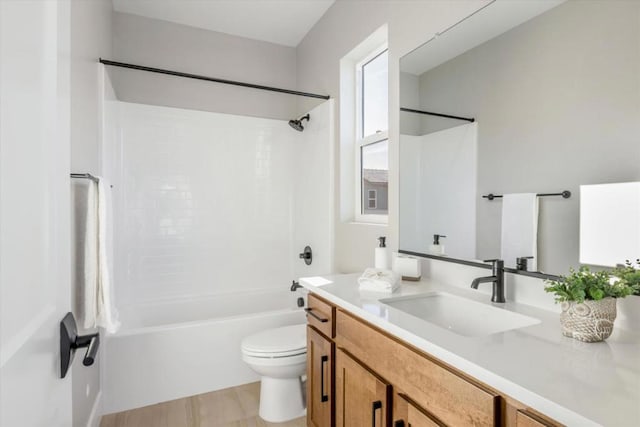 full bathroom with bathtub / shower combination, vanity, and toilet