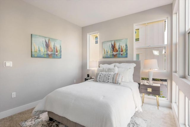 bedroom featuring light colored carpet