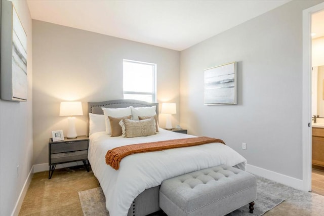 carpeted bedroom with ensuite bathroom