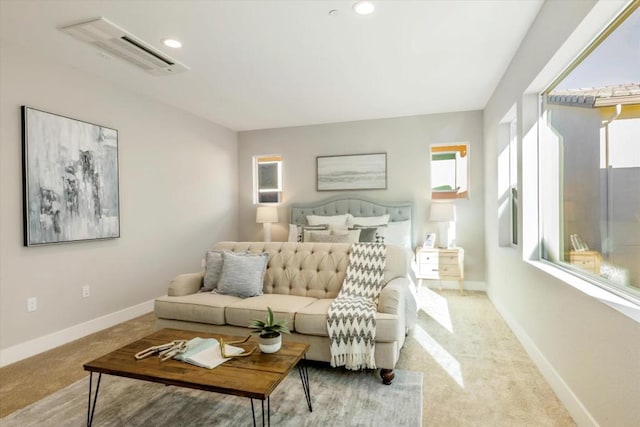 bedroom featuring a wall unit AC and light carpet