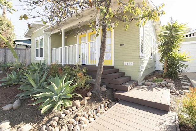 back of property featuring covered porch