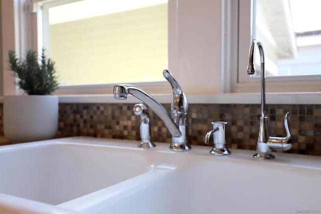 interior details featuring backsplash and sink