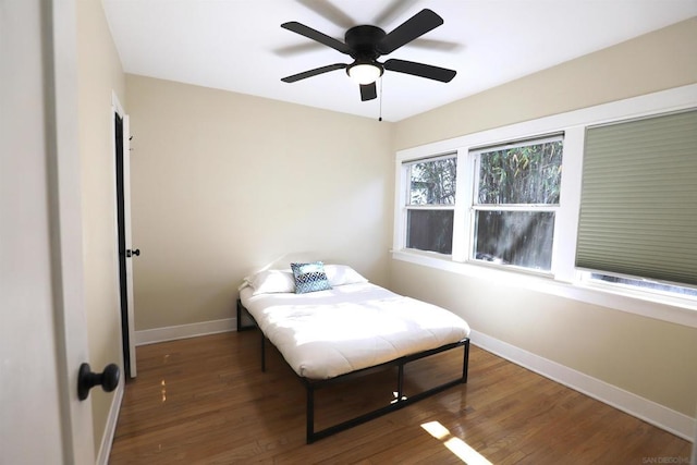 bedroom with ceiling fan and dark hardwood / wood-style flooring