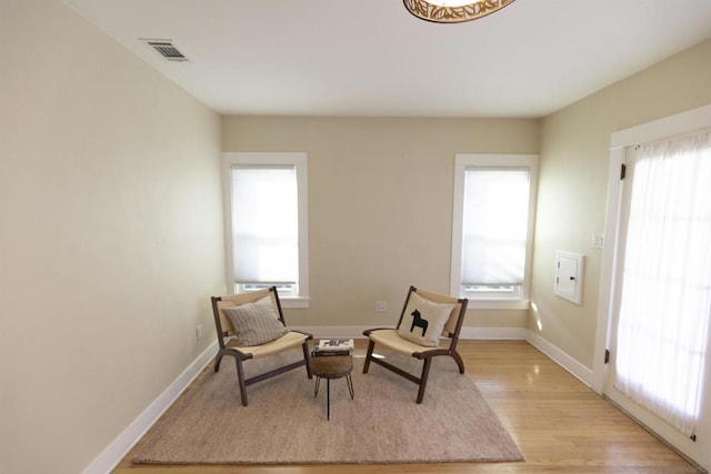 sitting room featuring light hardwood / wood-style floors and a healthy amount of sunlight