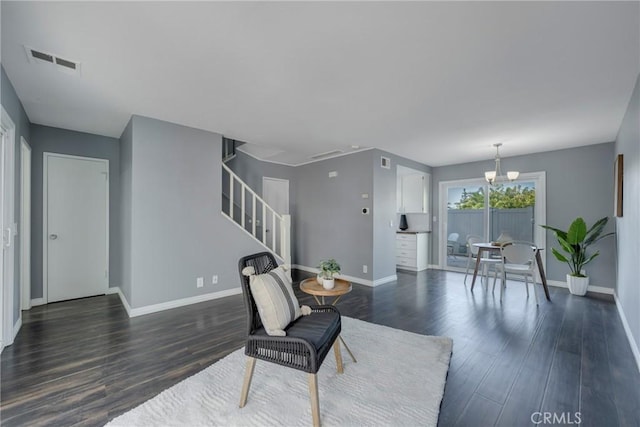 living room featuring dark hardwood / wood-style floors and a chandelier