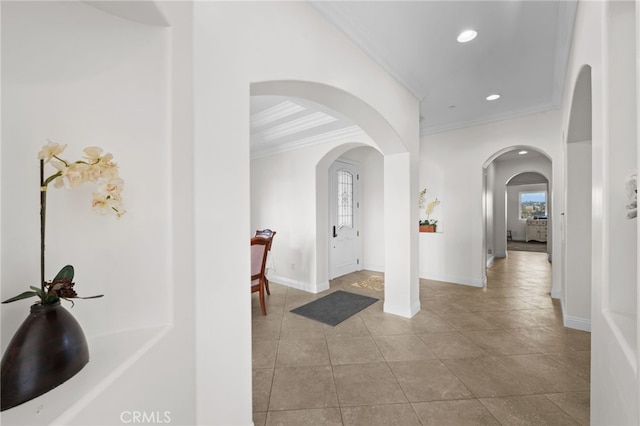 corridor featuring ornamental molding and light tile patterned flooring