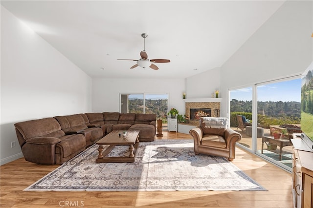 living room featuring light wood-type flooring, ceiling fan, and lofted ceiling