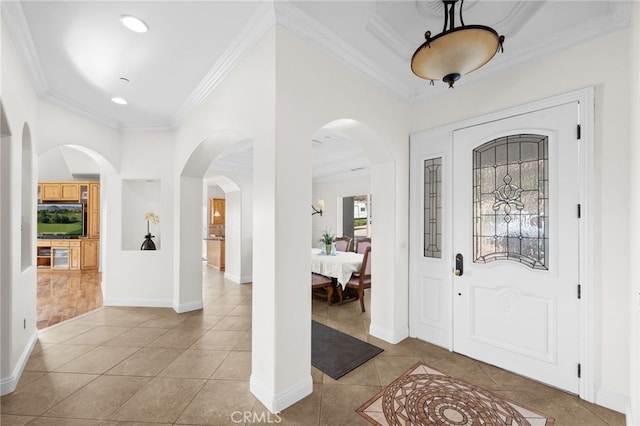 foyer featuring ornamental molding and light tile patterned floors