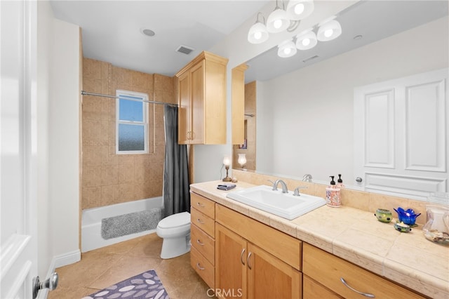 full bathroom featuring vanity, toilet, tile patterned floors, and shower / tub combo with curtain