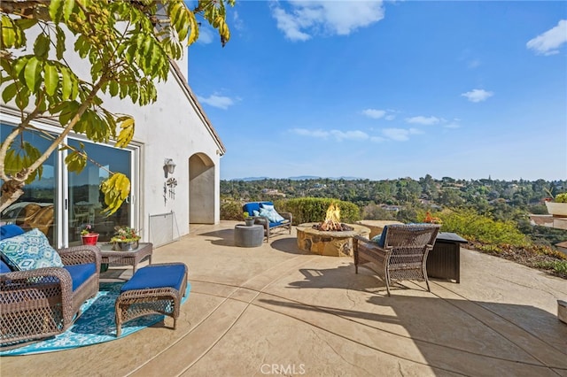 view of patio / terrace featuring a fire pit