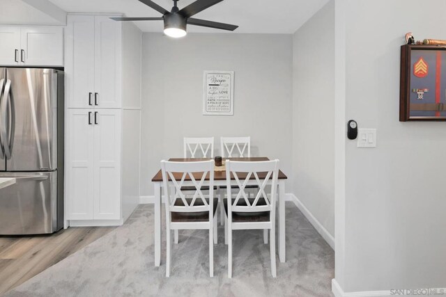 dining space with ceiling fan and light hardwood / wood-style floors