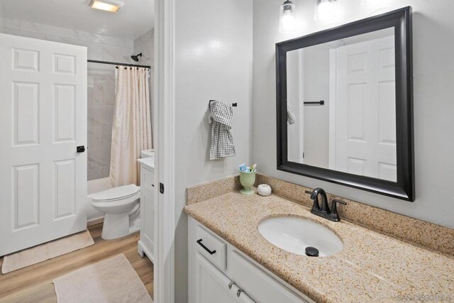 bathroom with toilet, wood-type flooring, and vanity