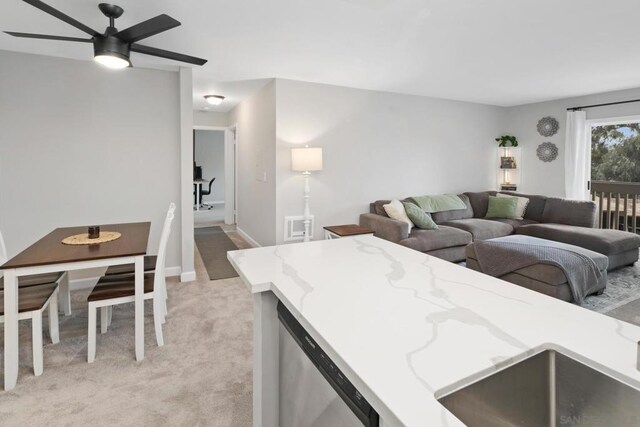 living room with ceiling fan and light colored carpet