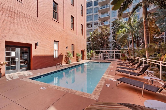 view of pool with a patio area and french doors