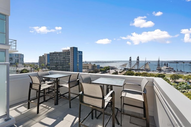 balcony with a water view and a bar