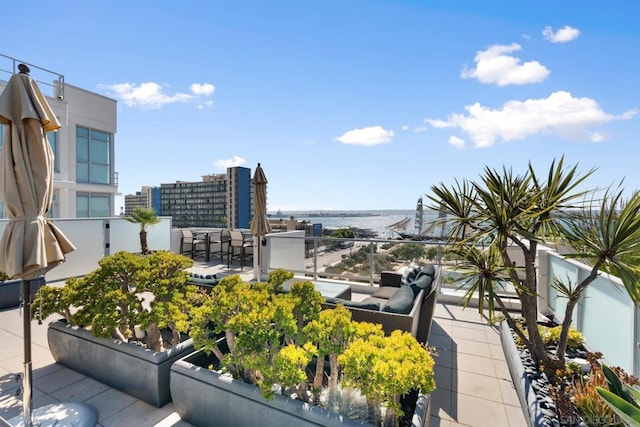 balcony featuring an outdoor hangout area and a water view