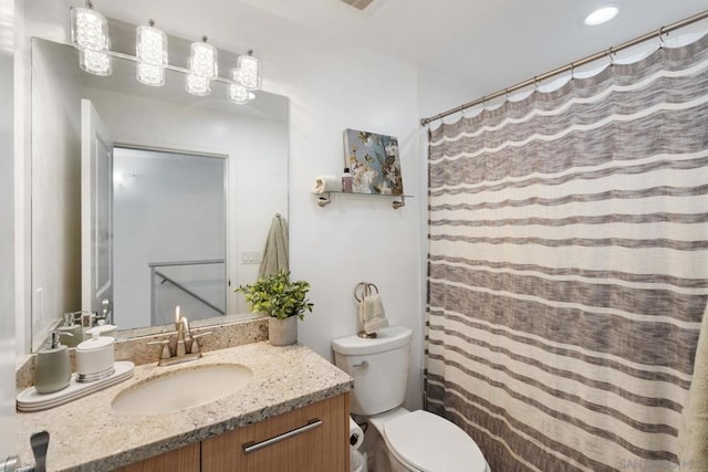 bathroom featuring toilet, a shower with curtain, and vanity