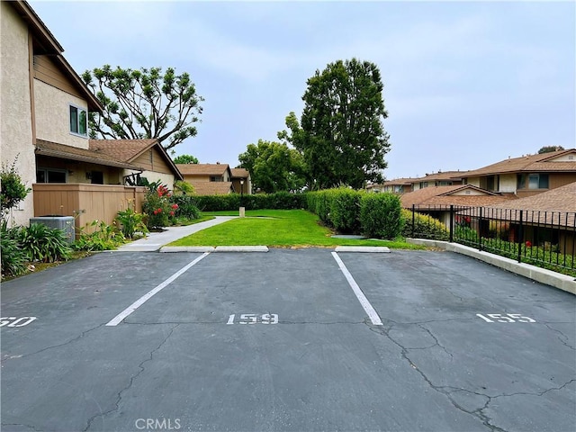 view of vehicle parking featuring a yard