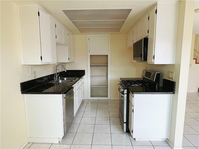 kitchen with light tile patterned floors, sink, white cabinets, and appliances with stainless steel finishes