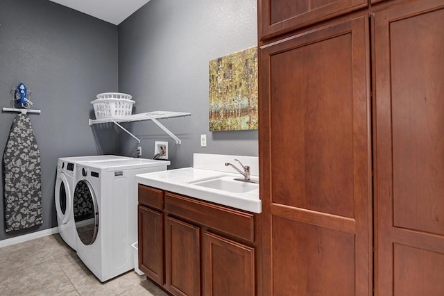 laundry room with cabinets, sink, independent washer and dryer, and light tile patterned flooring