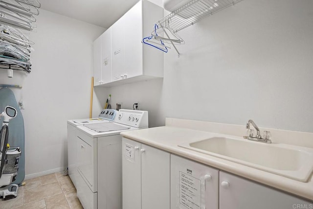 clothes washing area with light tile patterned floors, sink, independent washer and dryer, and cabinets