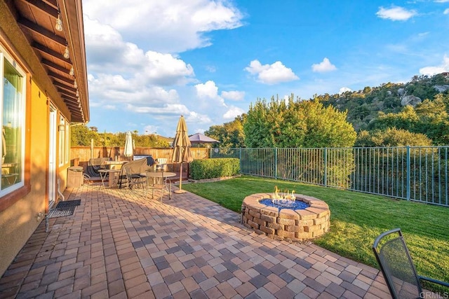 view of patio / terrace featuring an outdoor fire pit