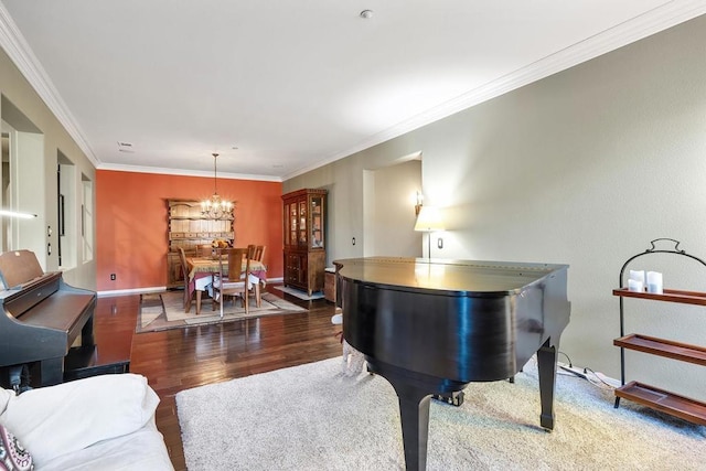 miscellaneous room featuring dark hardwood / wood-style flooring, crown molding, and a chandelier