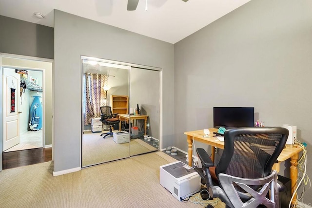 home office featuring ceiling fan and light carpet